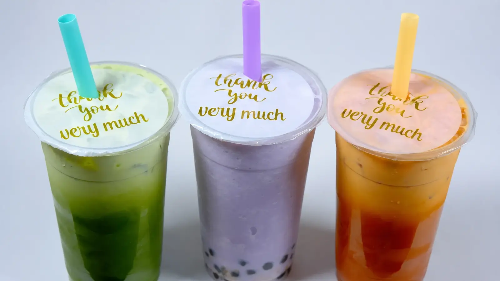Three house bubble teas: matcha, taro, and Thai tea, in 24-ounce cups