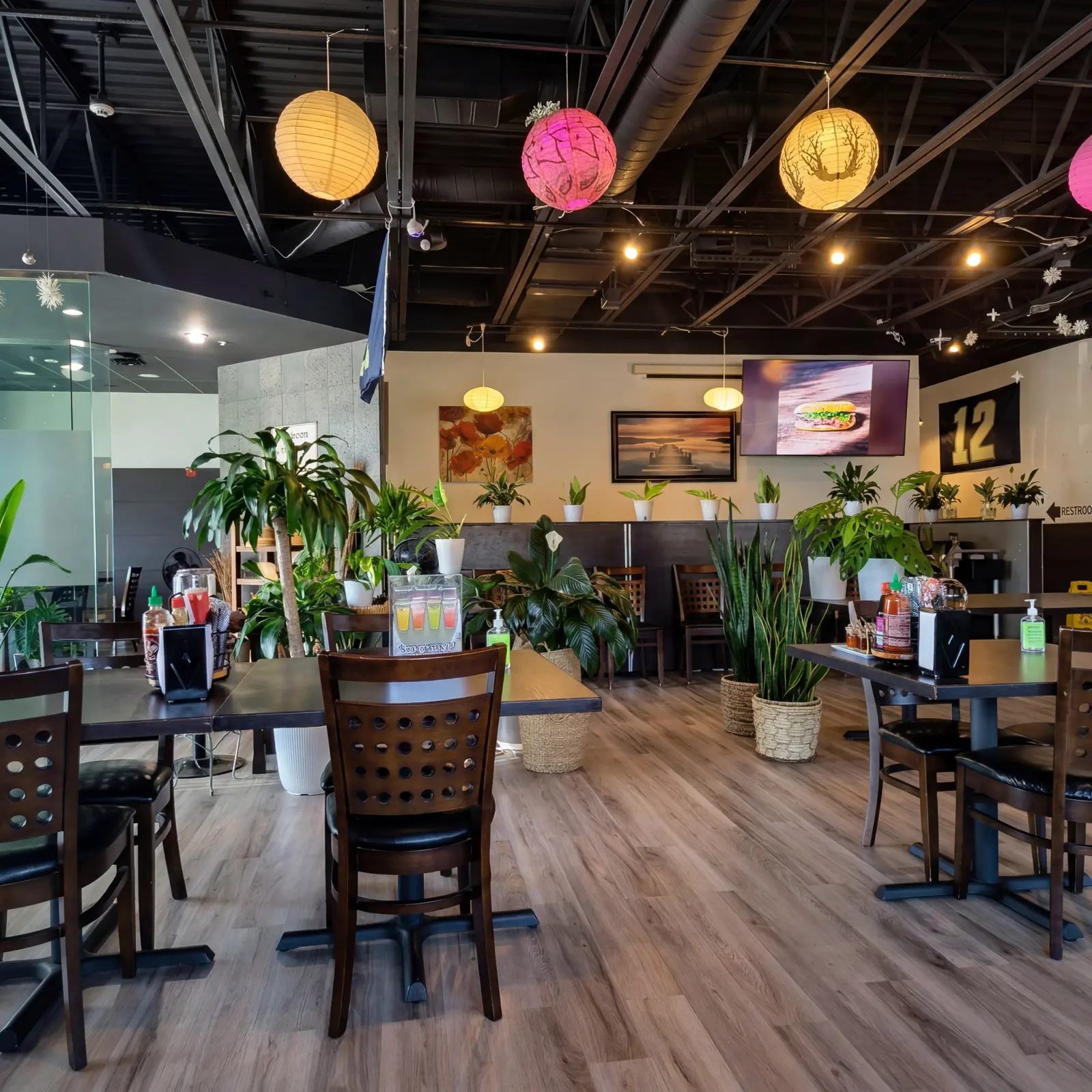 The Pho Viet Thai dining room in Lakewood, with pendant lanterns and tropical plants